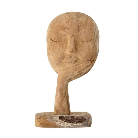 HAND-CARVED FACE RESTING ON HAND